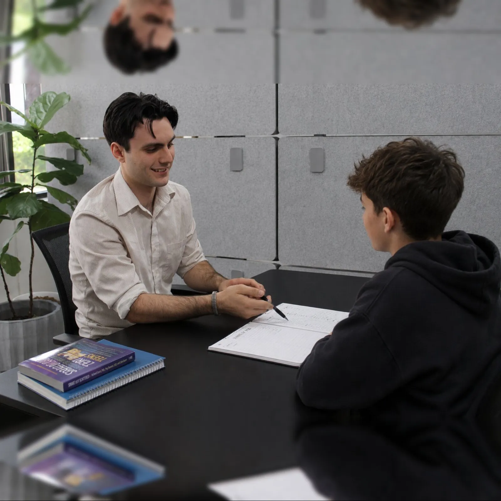 Executive function coach and a middle-school student working through a planner together